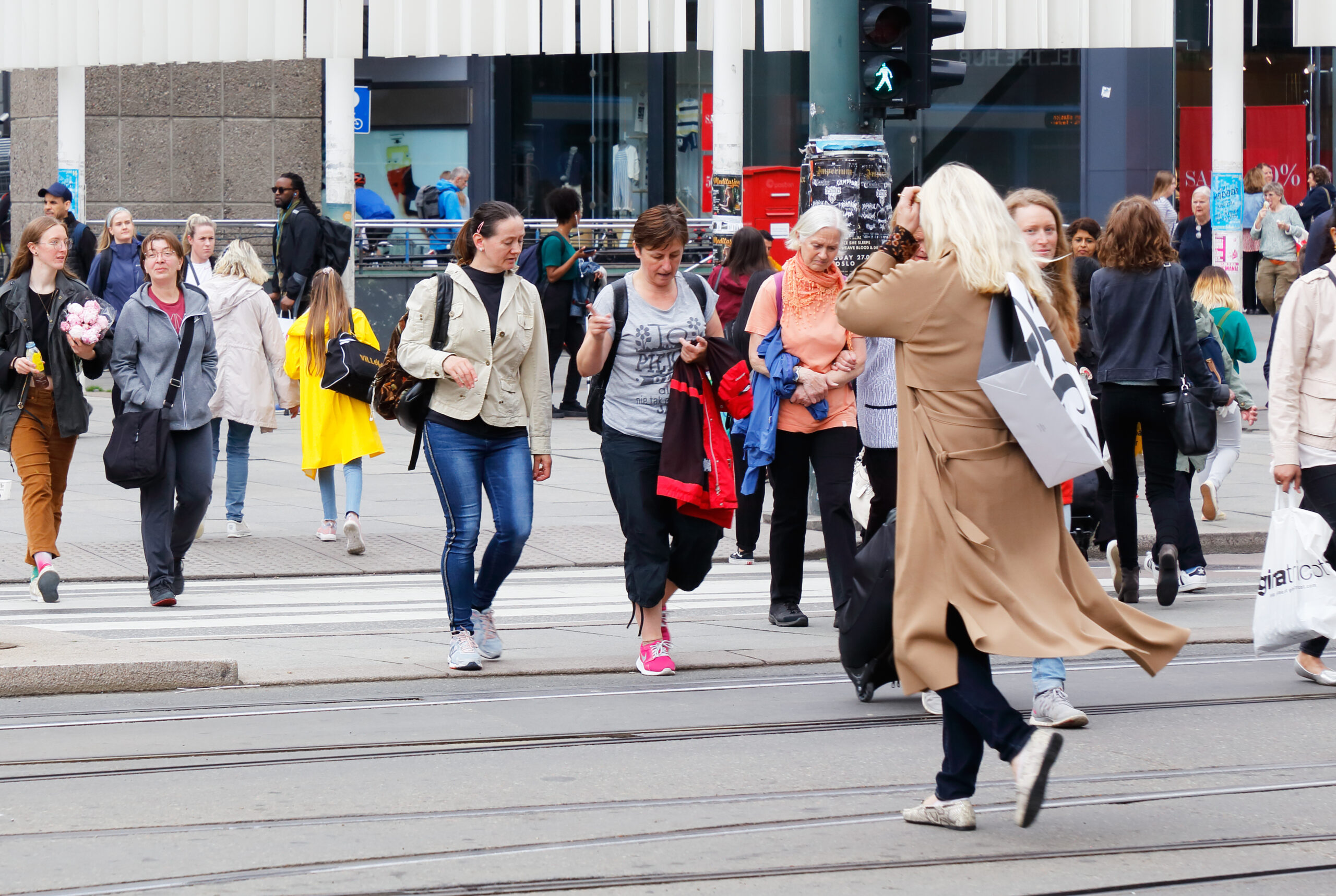 Oslo, Norway, June 20, 2019. People crossing the street at a crosswalk near the Central station.